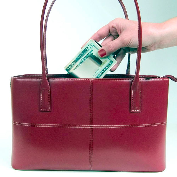 Storus® Smart Money Clip® shown being placed into a purse