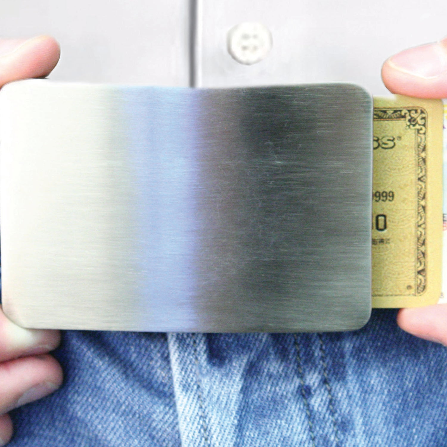 Storus Smart Belt Buckle on pants with cards being sliding out