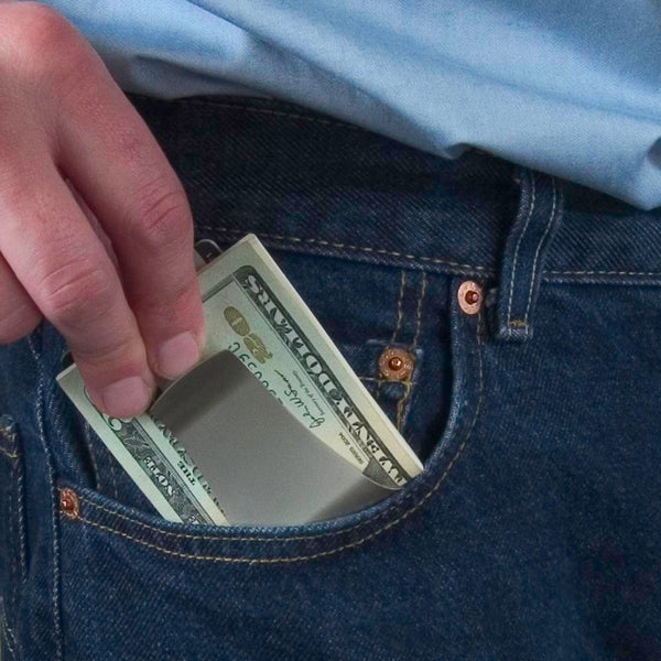 Storus® Smart Money Clip - shown bieng placed into a front pants pocket