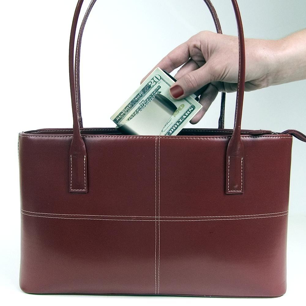 Smart Money Clip being placed into a purse