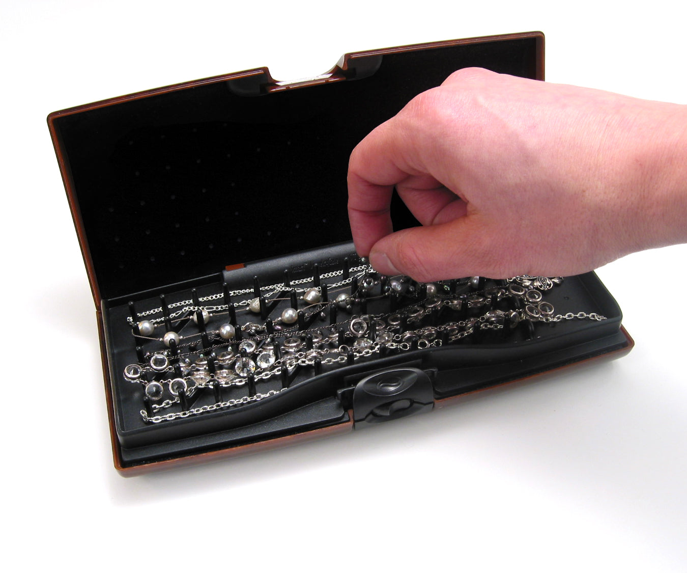 Storus Smart Jewelry Case® - hand grabbing necklaces on peg side tangle free side